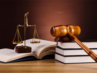 balance scale, gavel and books on court table